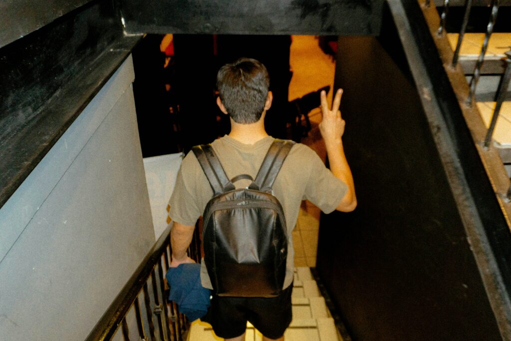 person walking down stairs in a backpack
